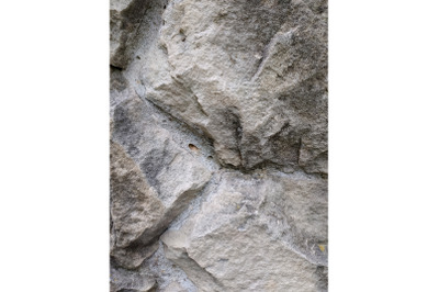 Grey stone cement wall background stonewall rubble facade closeup