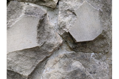 Grey stone cement wall background stonewall rubble facade closeup