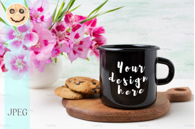 Black campfire enamel mug mockup with pink clarkia flowers.