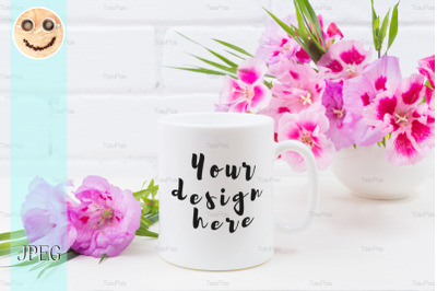 White coffee mug mockup with pink godetia flowers.