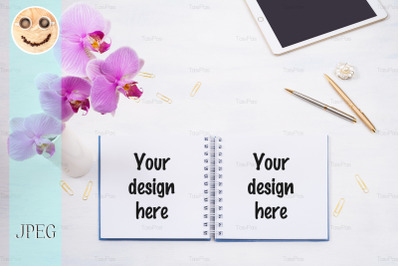 Notepad mockup with tablet and pink orchid on the white table.