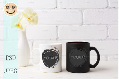 White and black mug mockup with soft yellow orchid in vase