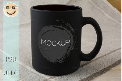 Black coffee mug mockup on the linen napkin.