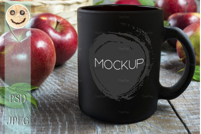 Black coffee mug mockup with apples.