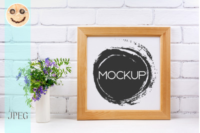 Square wooden picture frame mockup with bird vetch.