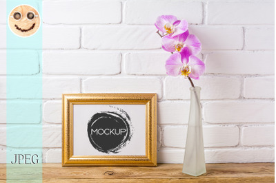 Gold decorated landscape frame mockup with pink orchid