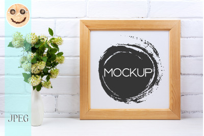 Square wooden picture frame mockup with white spirea