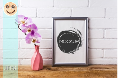 Silver frame mockup with orchid in pink twisted vase