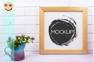 Wooden square picture frame mockup with pink clover