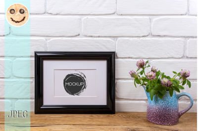 Black landscape frame mockup with pink clover