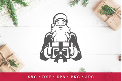 Santa Claus smiling and holding gift in hands. Vector Christmas illust