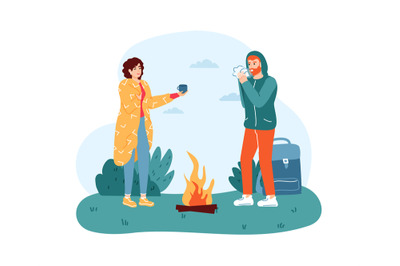 Woman and man travelers standing near campfire. Girl in blanket giving