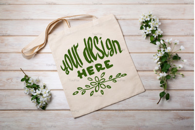 Rustic tote bag mockup with blooming apple tree branch