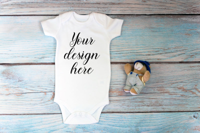 Baby Bodysuit mockup with toy on a wooden background.