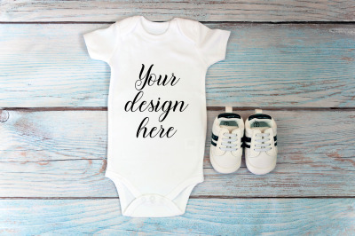 Baby Bodysuit mockup on a wooden background.