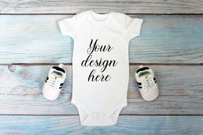 Baby Bodysuit mockup on a wooden background.