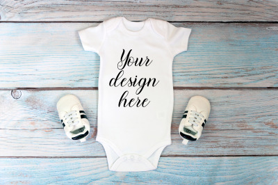 Baby Bodysuit mockup on a wooden background.