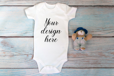 Baby Bodysuit mockup with toy on a wooden background.