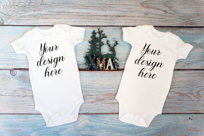 Two Christmas baby bodysuits Mockup on a wooden background.