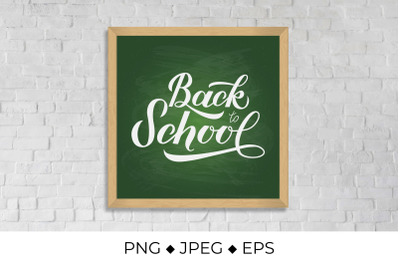 Back to school calligraphy hand lettering on green board with wooden f