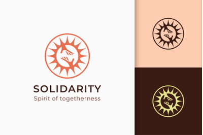 Charity or Donation Logo in Hand and Sun