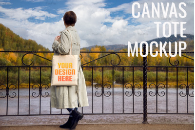 Woman in classic trench coat holding tote bag mockup.