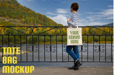 Woman in striped long sleeve shirt holding canvas tote mockup