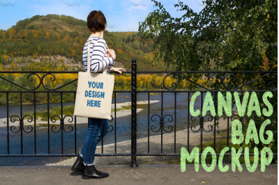 Woman holding tote looking at the river mockup