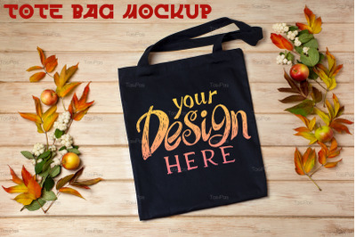 Black tote bag mockup with fall leaves and snowberry