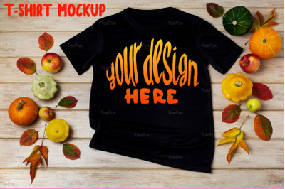 Unisex black T-shirt mockup with fall decor.