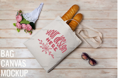 Tote bag mockup with pink flowers and french baguette.