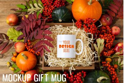 White coffee mug mockup with pumpkins and fall leaves.