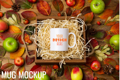 White coffee mug mockup with fall leave and pine cones.