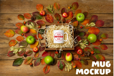 White coffee mug fall mockup with wooden gift box and pine cones
