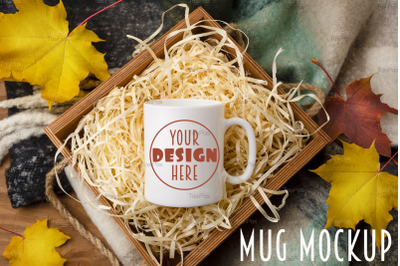 White coffee mug mockup with gift box and maple leaves.
