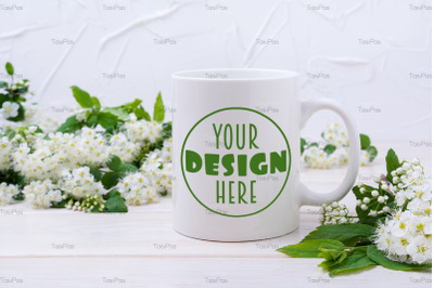 White coffee mug mockup with viburnum flowers.
