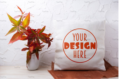 Pillow mockup with red grass in the vase.