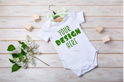 White cotton baby short sleeve onesie mockup with white lilac.