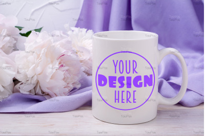 White coffee mug mockup with pink peony and lilac scarf.