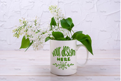 White coffee mug mockup with blooming white lilac.