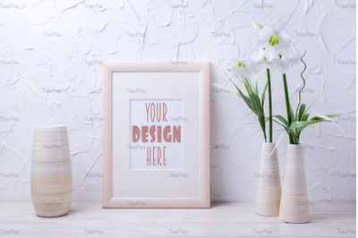 Wooden frame mockup with lily and striped vase.