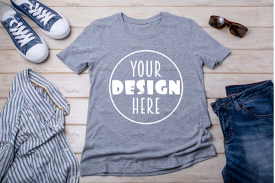 Gray T-shirt mockup with sneakers and striped shirt.