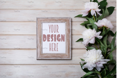 Wooden picture frame mockup with pale pink peony.