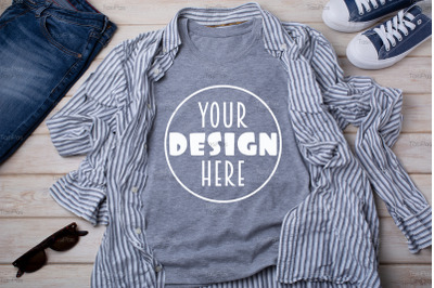 Gray T-shirt mockup with striped shirt and jeans.