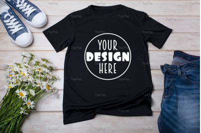 Black T-shirt mockup with daisy flowers and jeans.