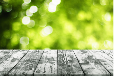 Black Wood Plank Empty Table with Green Blurred Bokeh Background