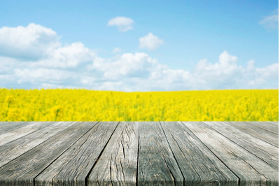 Empty Rustic Plank Wood Table with Blurred flowers field Background