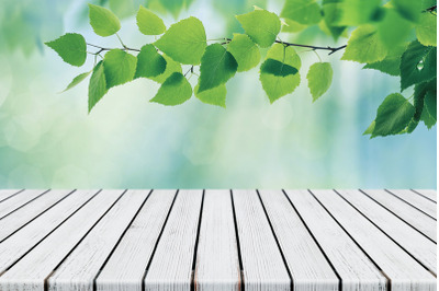 Empty White Plank Wood Table Top Foliage With Blurred Green Background