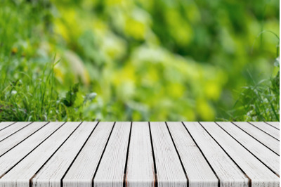 Empty White Plank Wood Table With Bokeh Green Foliage Background