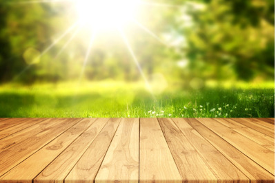 Empty Wood Plank Table With Blurred Green Bokeh Sunlight Background